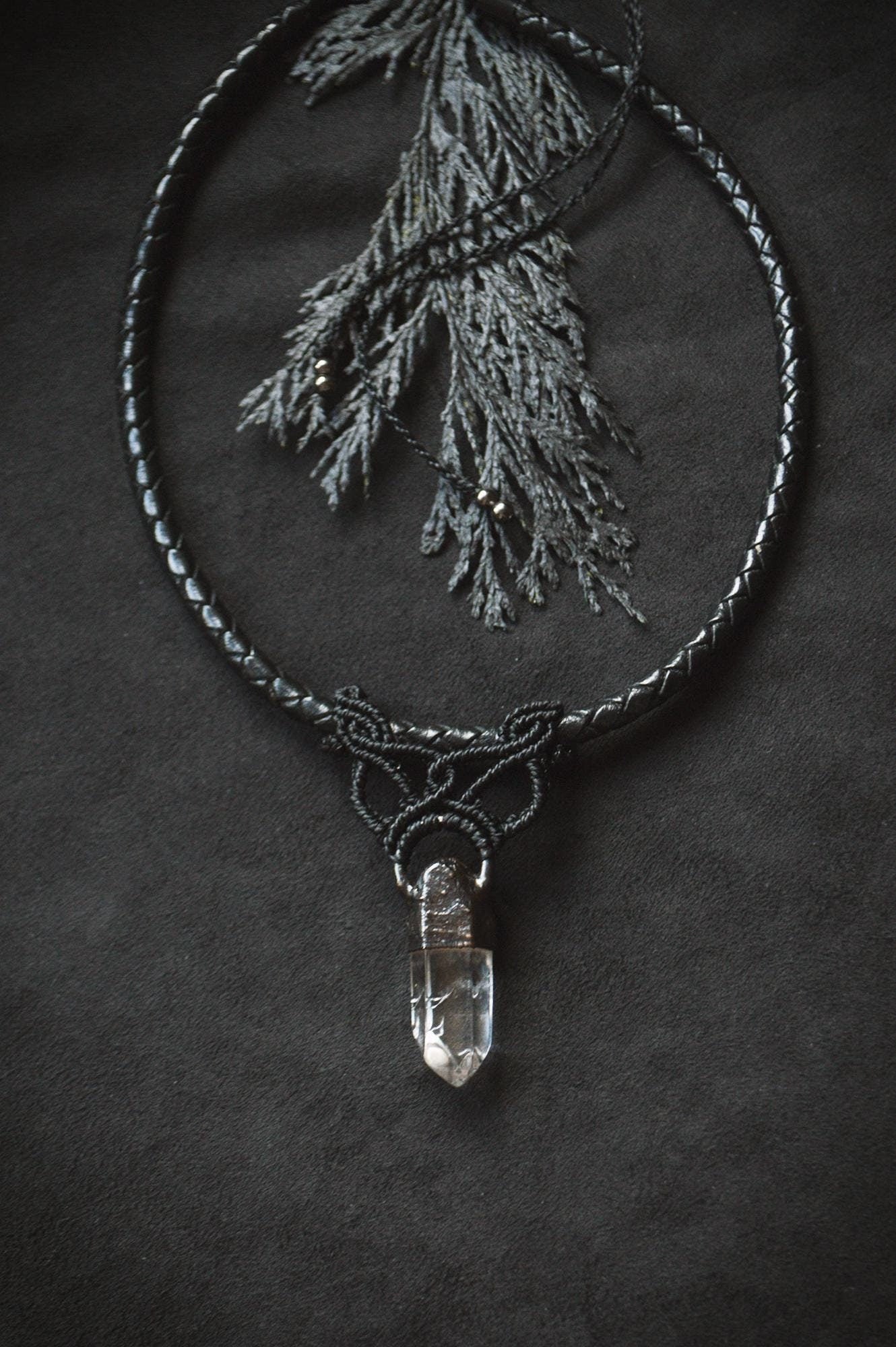 quartz pendant with black macrame detail, on a weaved leather necklace. adjustable with a sliding clasp. gender neutral