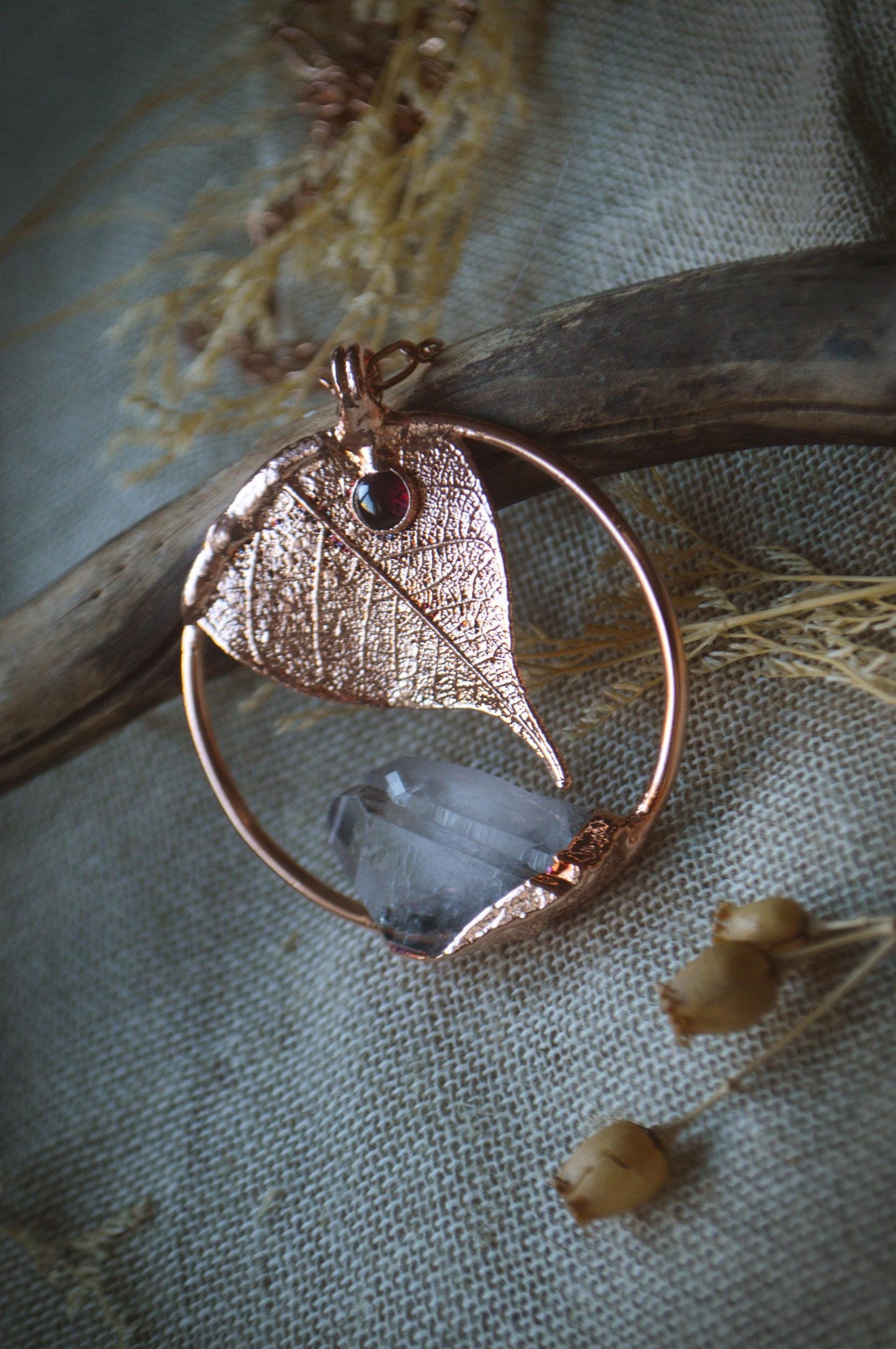 Unique piece. Skeleton leaf formed in copper. Botanical pendant with raw quartz and garnet