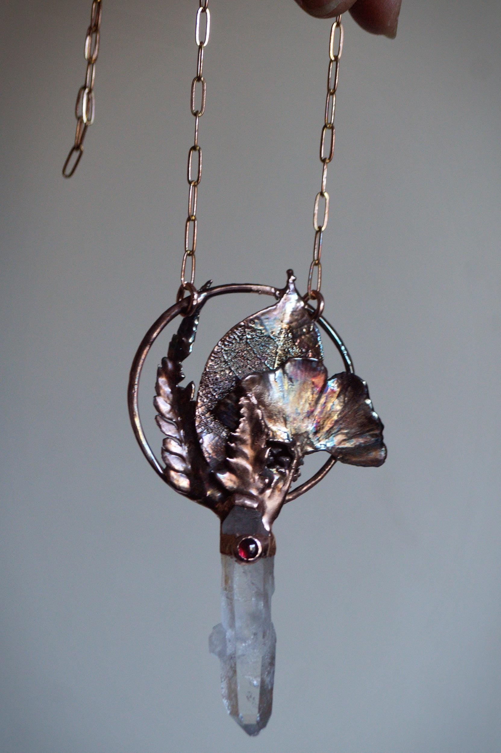 Real leaves bouquet formed in copper. Botanical pendant with raw quartz and garnet