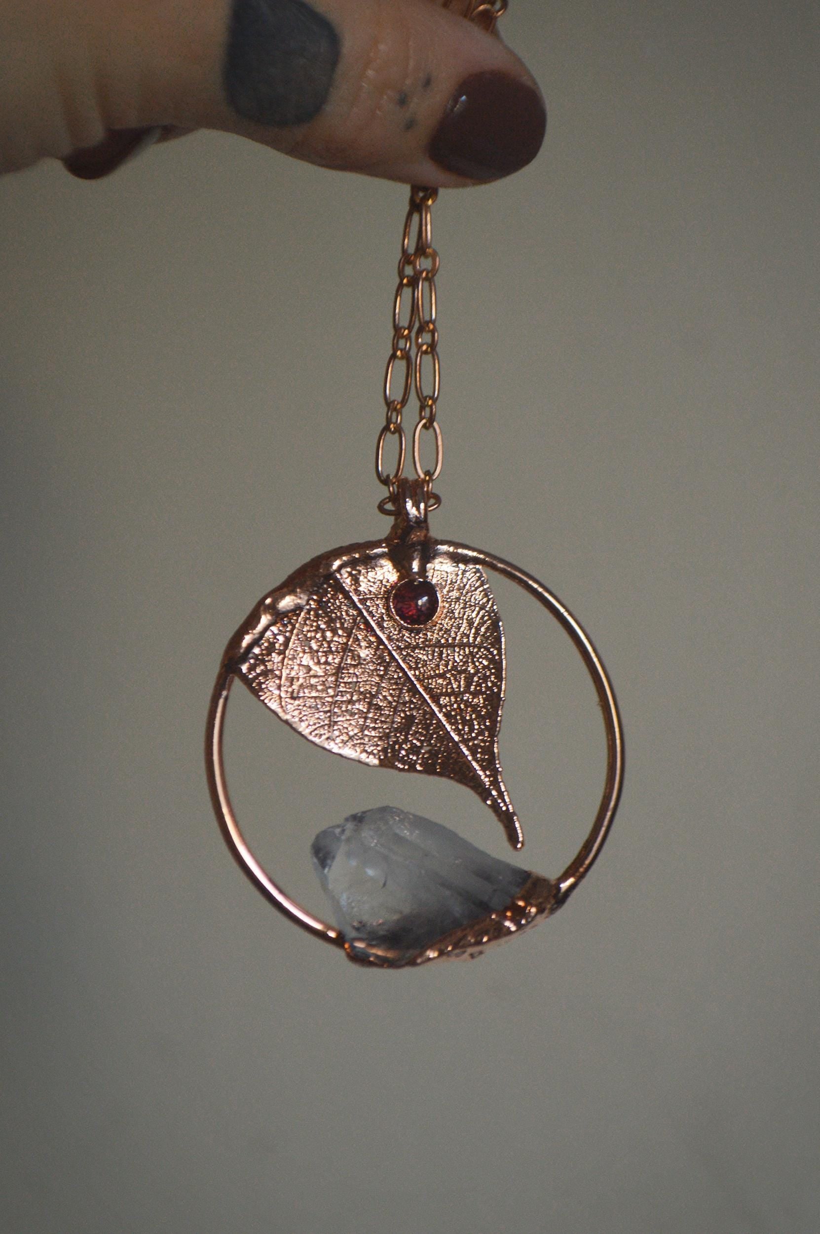Unique piece. Skeleton leaf formed in copper. Botanical pendant with raw quartz and garnet