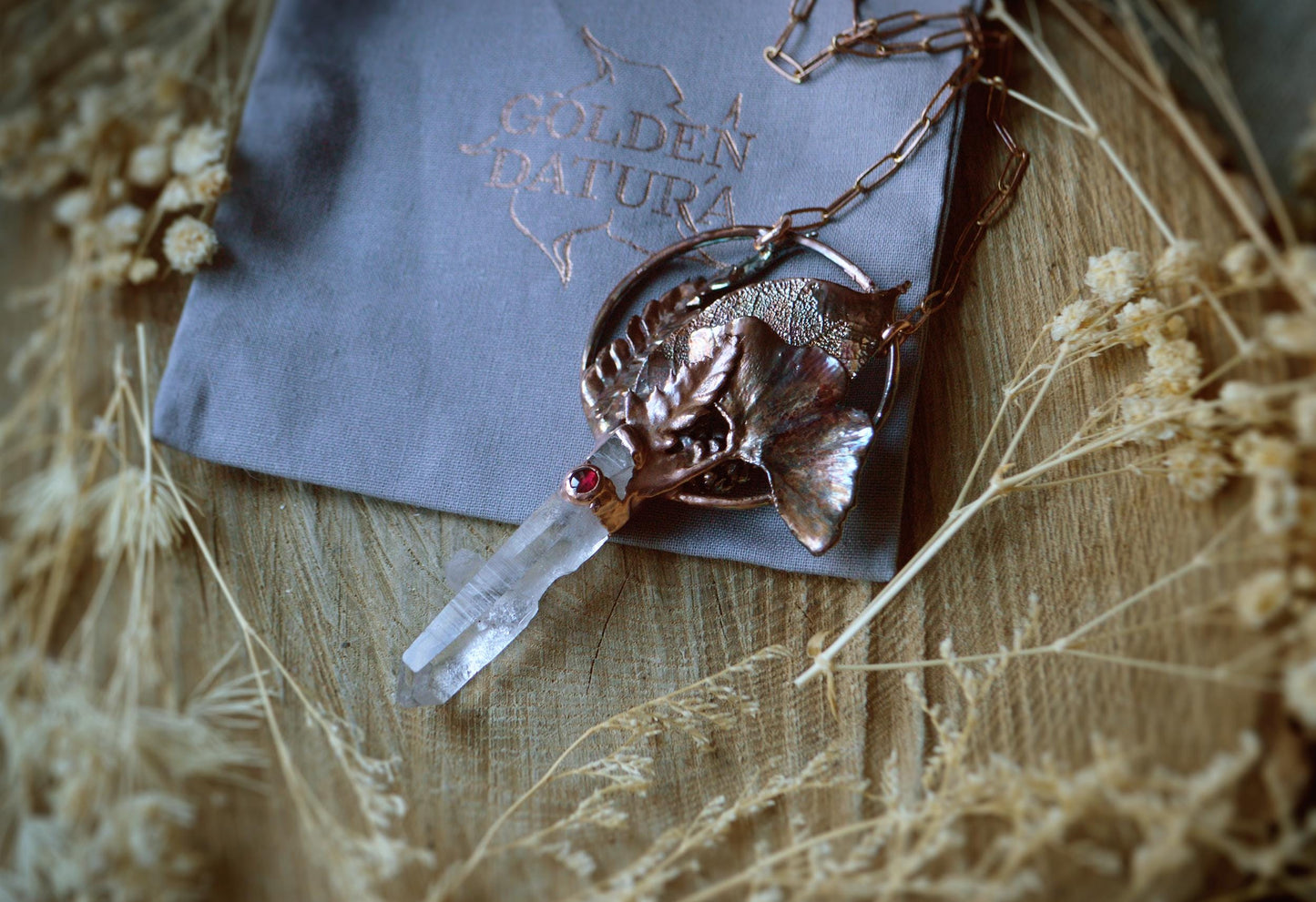Real leaves bouquet formed in copper. Botanical pendant with raw quartz and garnet