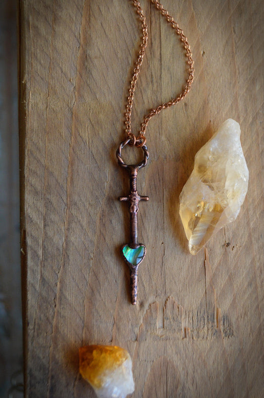 Heart and dagger necklace with abalone shell. Romantic goth pendant